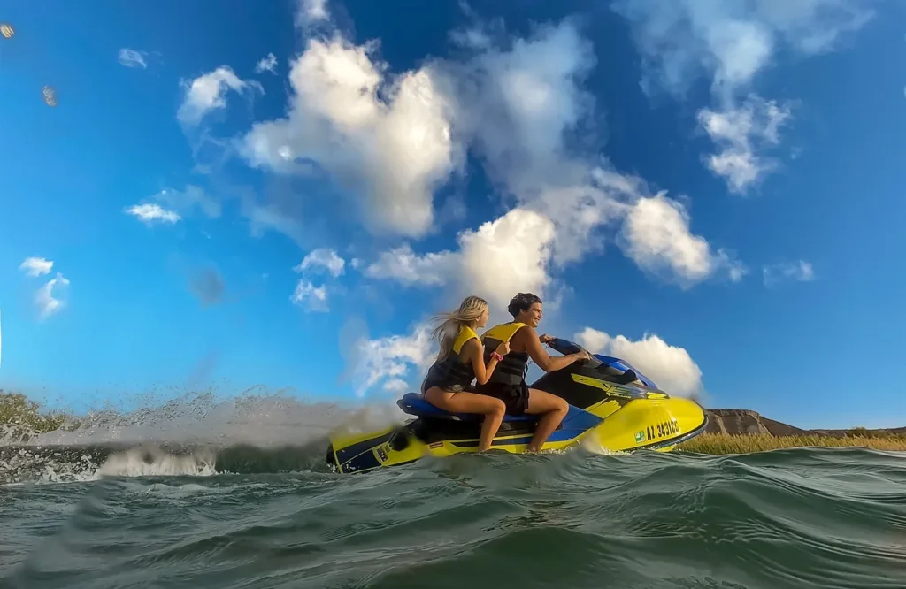 Two People Riding A Yellow Jet Ski
