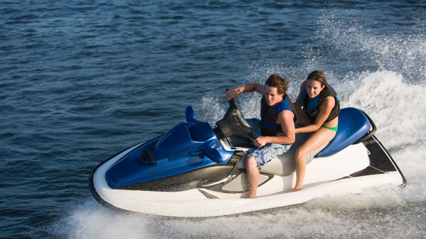 Couple Riding A Jet Ski
