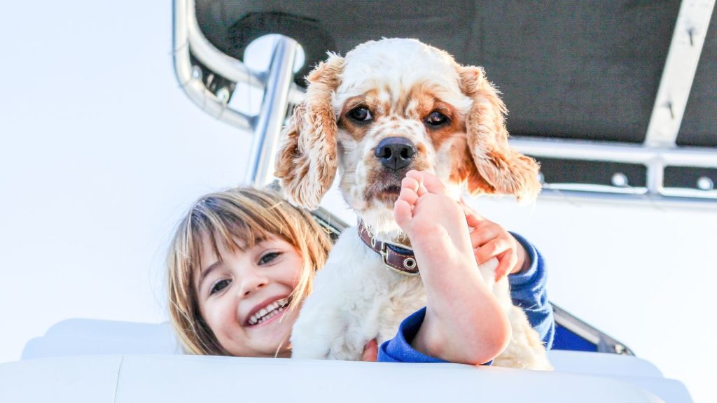 Child And Dog On Boat