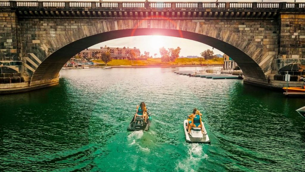 Jet Skis Passing Under Bridge
