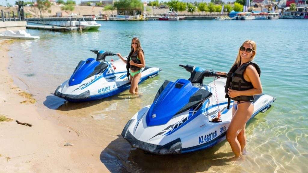 Women Standing By Jet Skis
