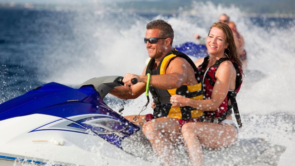 Couple Enjoying Jet Ski Ride On Water
