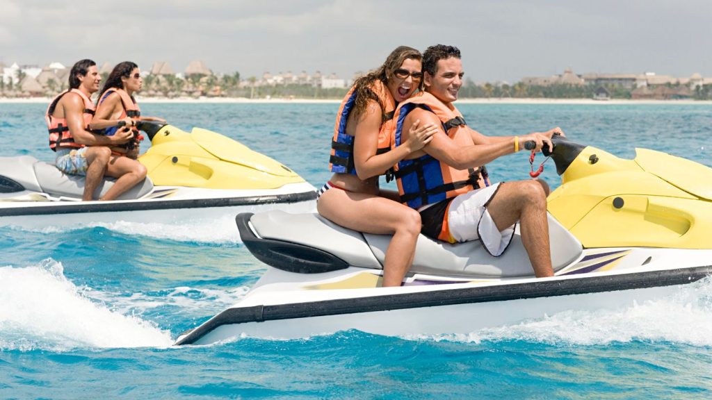 Couples Riding Jet Skis In The Ocean
