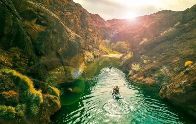 A People Riding Jet Ski in Beautiful Scenery